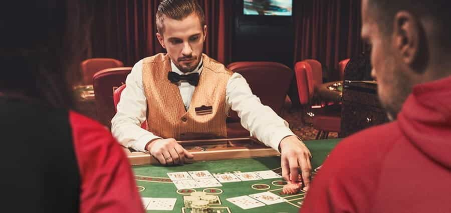 A croupier dealing cards in a casino.