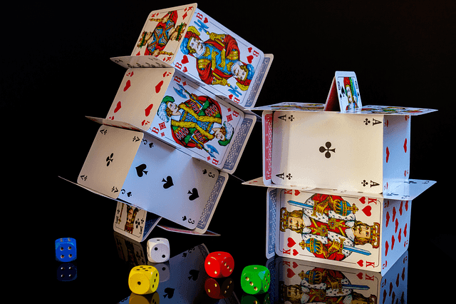 Stacks of cards next to multi-colored dice.