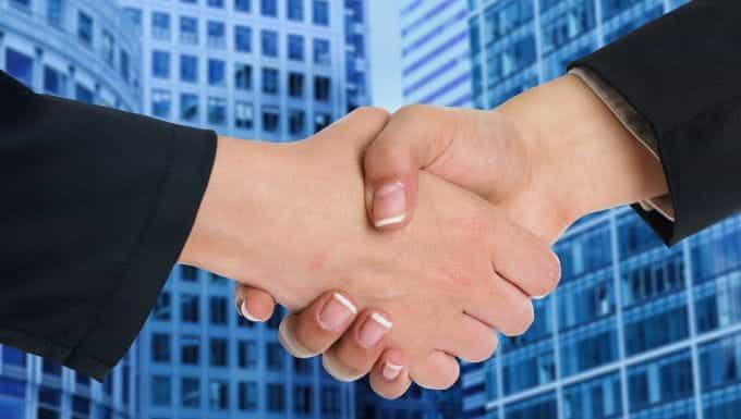 A handshake in front of an office building.