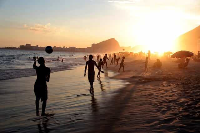 Football being played on a beach in the middle east.