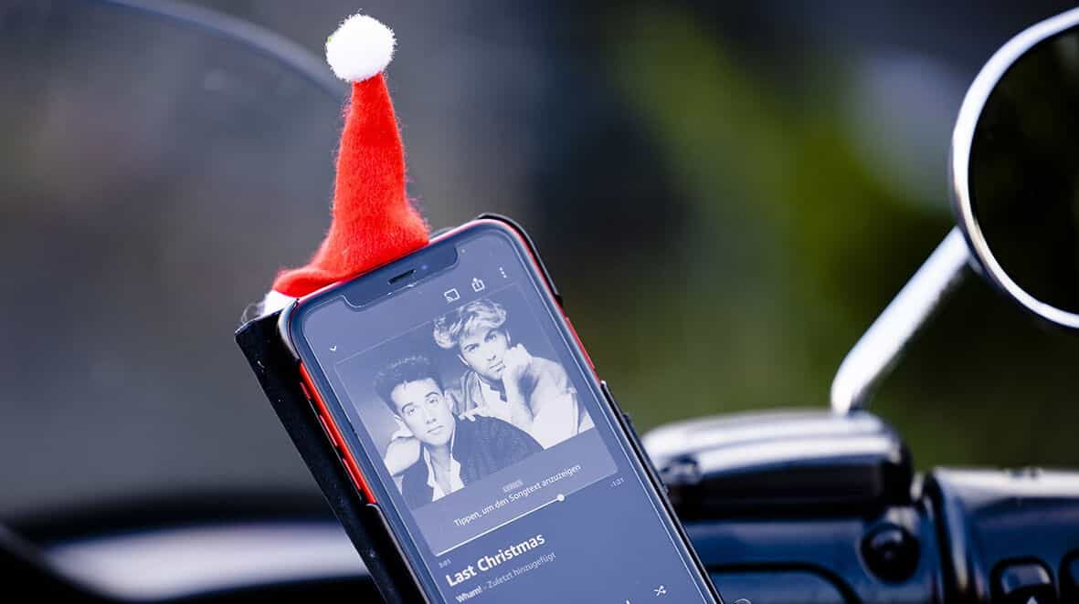 A mobile phone showing Wham’s Last Christmas on its screen.