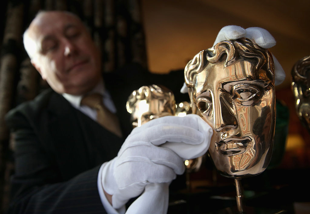 A BAFTA trophy gets a quick polish from an official.